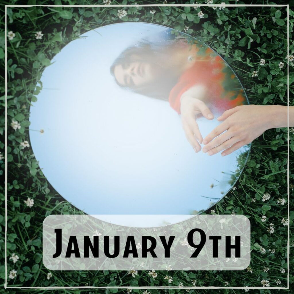 January 9th - a circular mirror in the grass with someone looking down into it