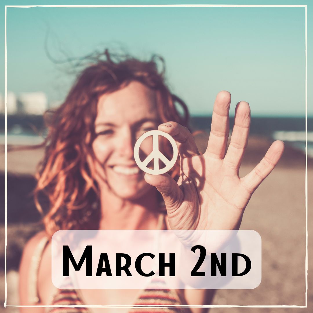 March 2nd - a person at the beach holding up a peace sign