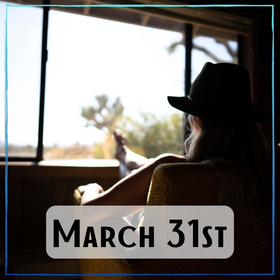 March 31st - a backlit shadow of someone sitting with their feet up looking out a window