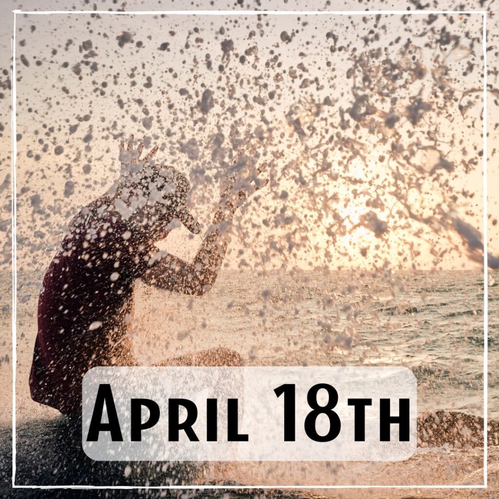 April 18th - a person with their arms up and a wave having cast up a lot of sea spray