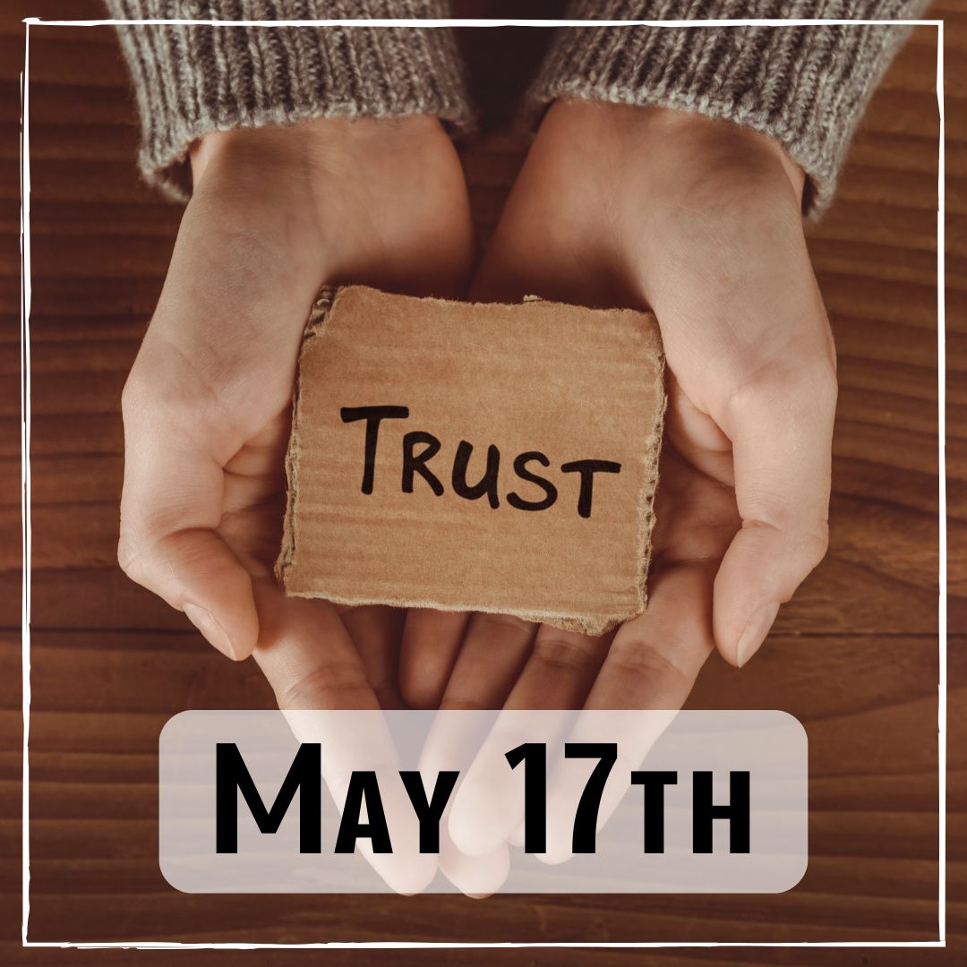 May 17th - hands holding a wooden block with the word "trust" written on it