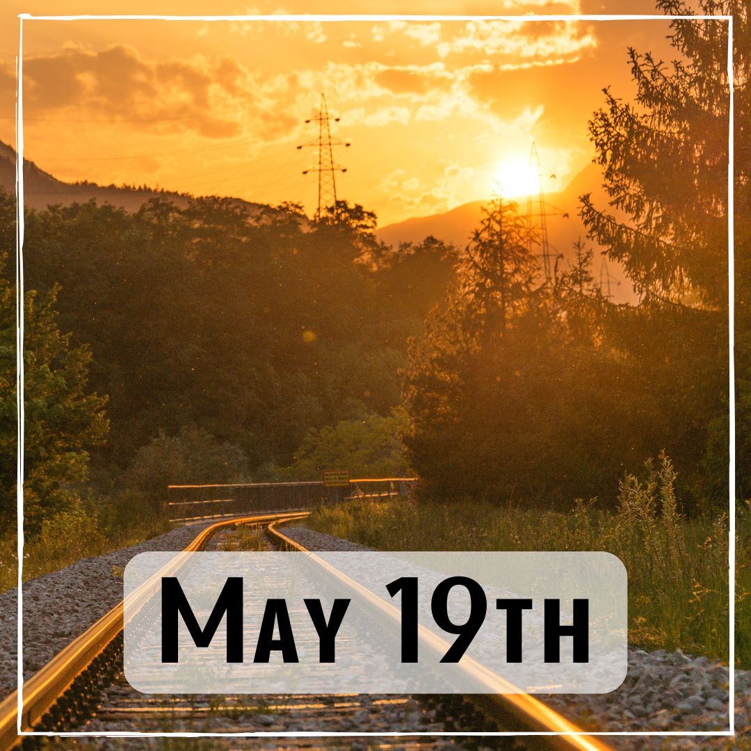 May 19th - a set of train tracks in the mountain with a sunrise background