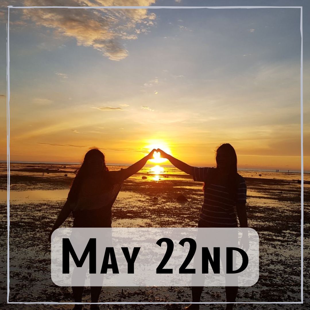 May 22nd - two people at the beach with their hands forming a heart around the sunrise