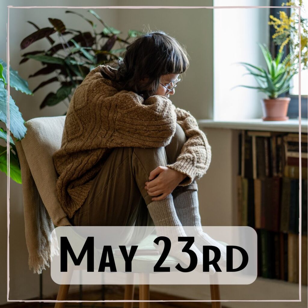 May 23rd - a person curled up in a chair hugging their legs