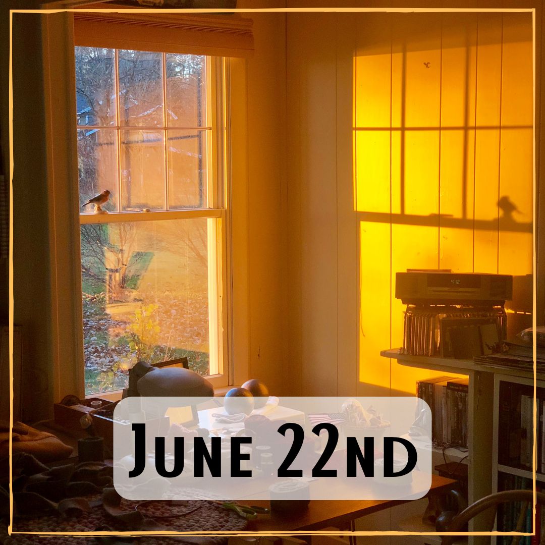 June 22nd - a cluttered bedroom window and desk at sunrise
