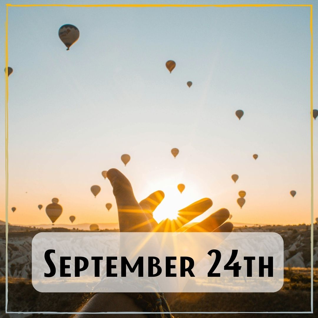 September 24th - a person reaching out at sunset towards a sky full of hot air balloons