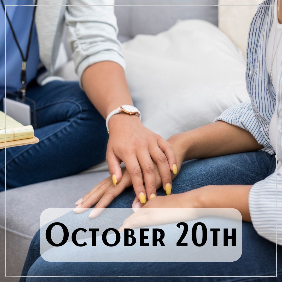 October 20th - two people sitting together, one with their hand over the other