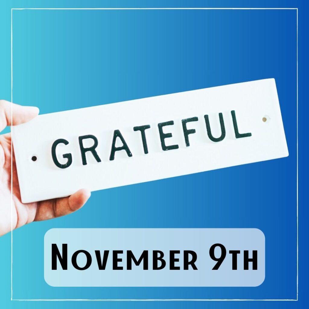 November 9th - a hand holding a sign with the word "Grateful"