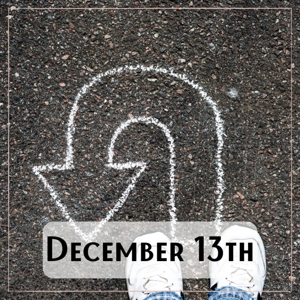December 13th - a person standing on the asphalt with a chalk drawn u-turn shape arrow