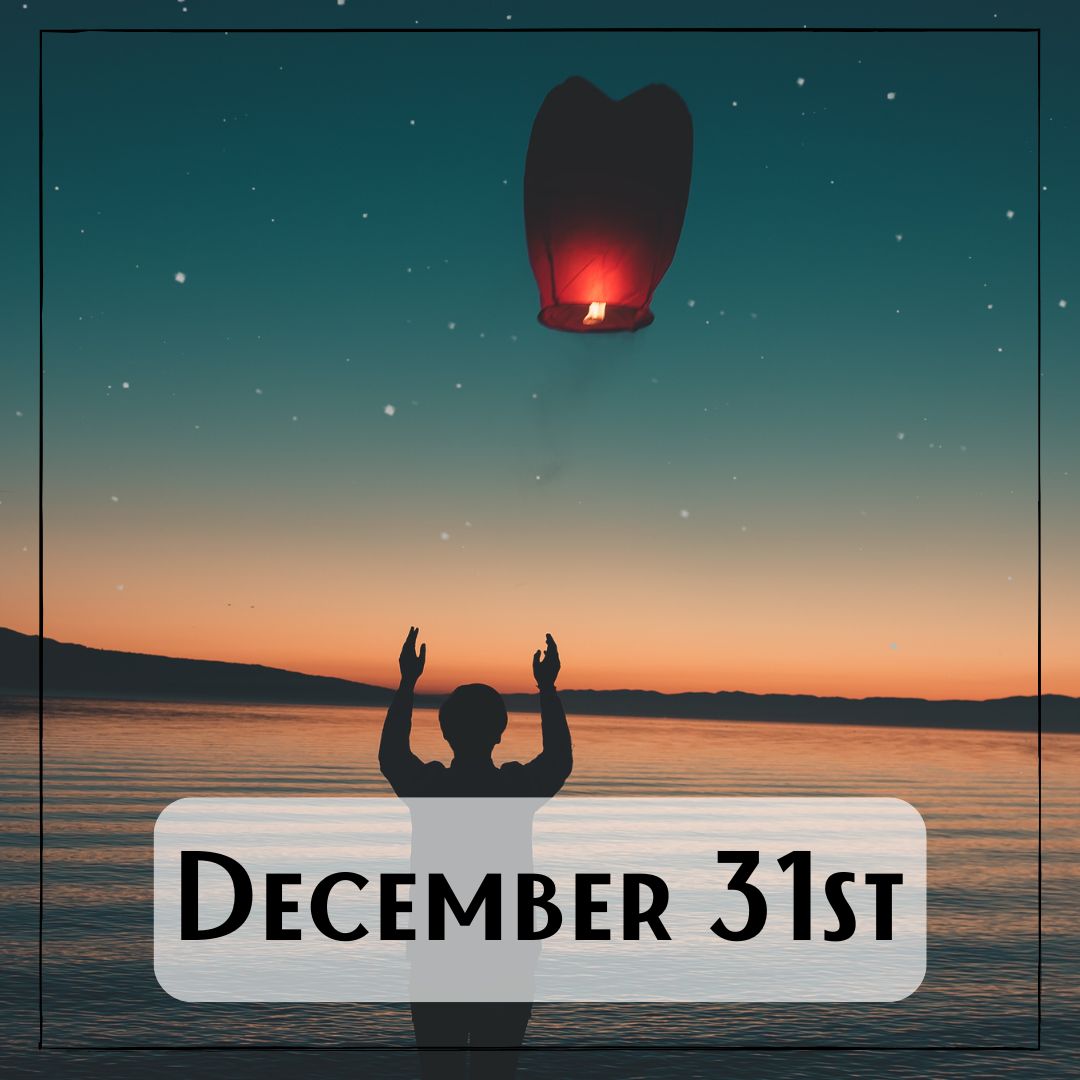 December 31st - a person releasing a red paper wishing lantern at sunset