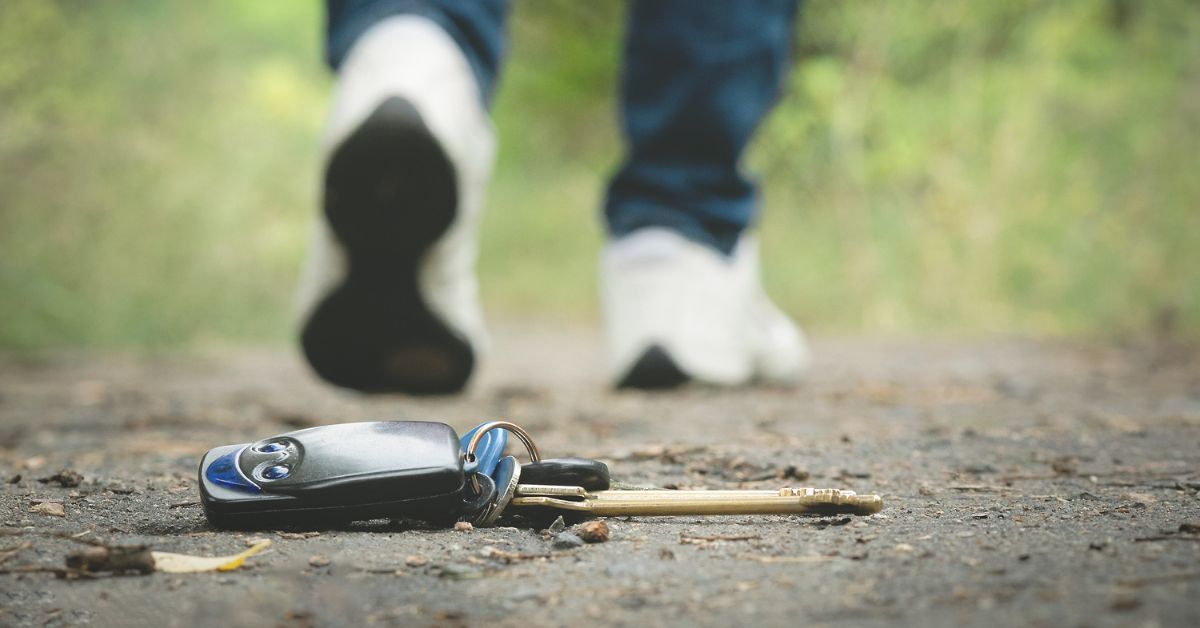 Someone walking away from keys dropped on the ground