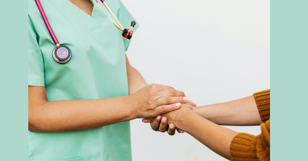 A dr touching hands with a patient