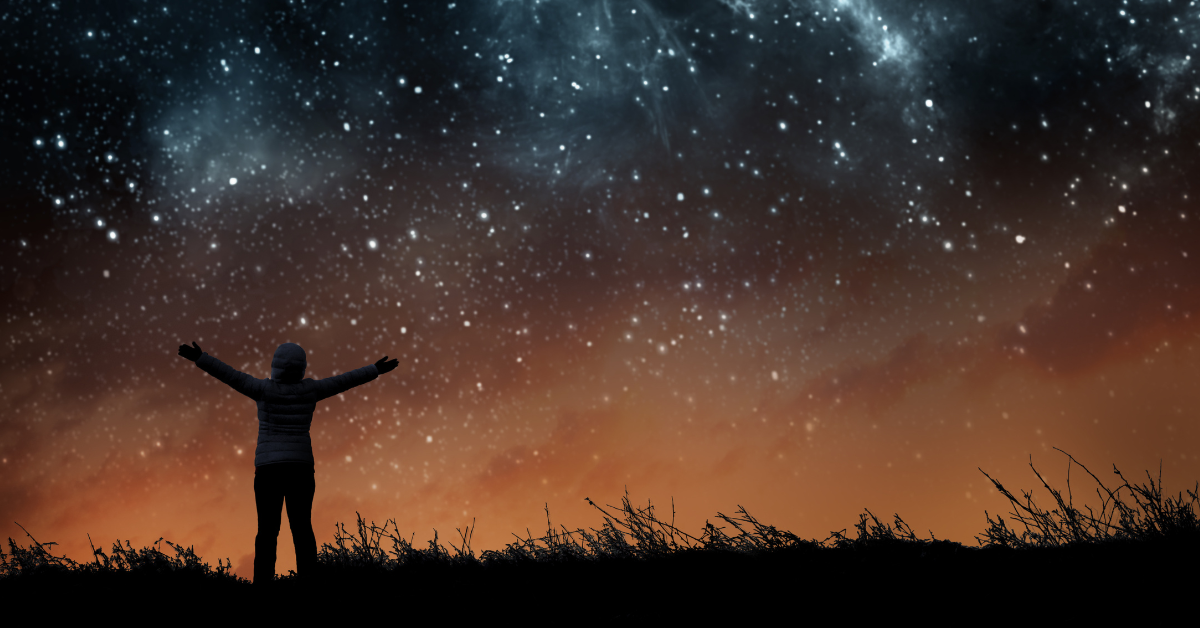 A person reaching out to the stars