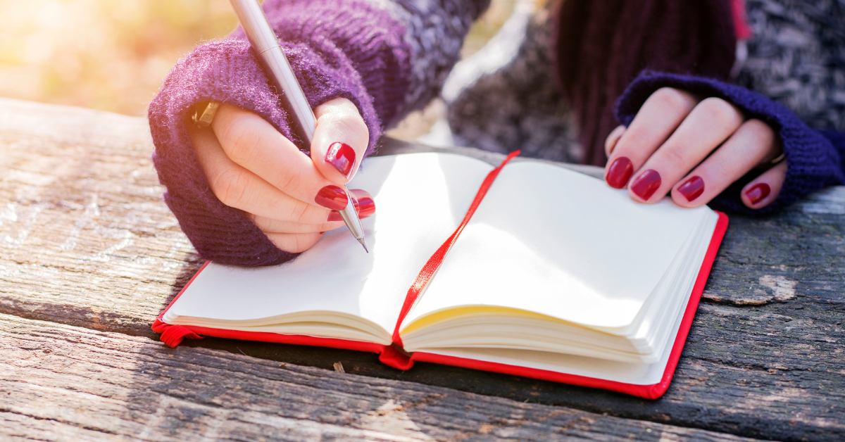person writing in a journal