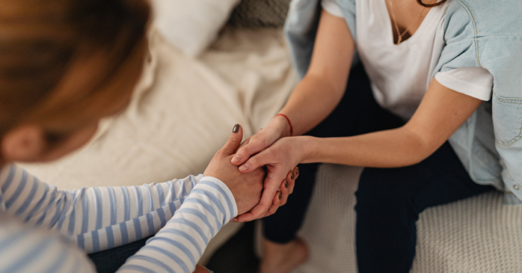 two women holding hands
