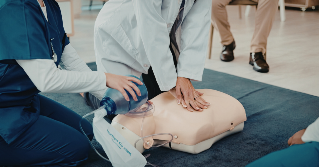 People practicing CPR on a life-sized doll
