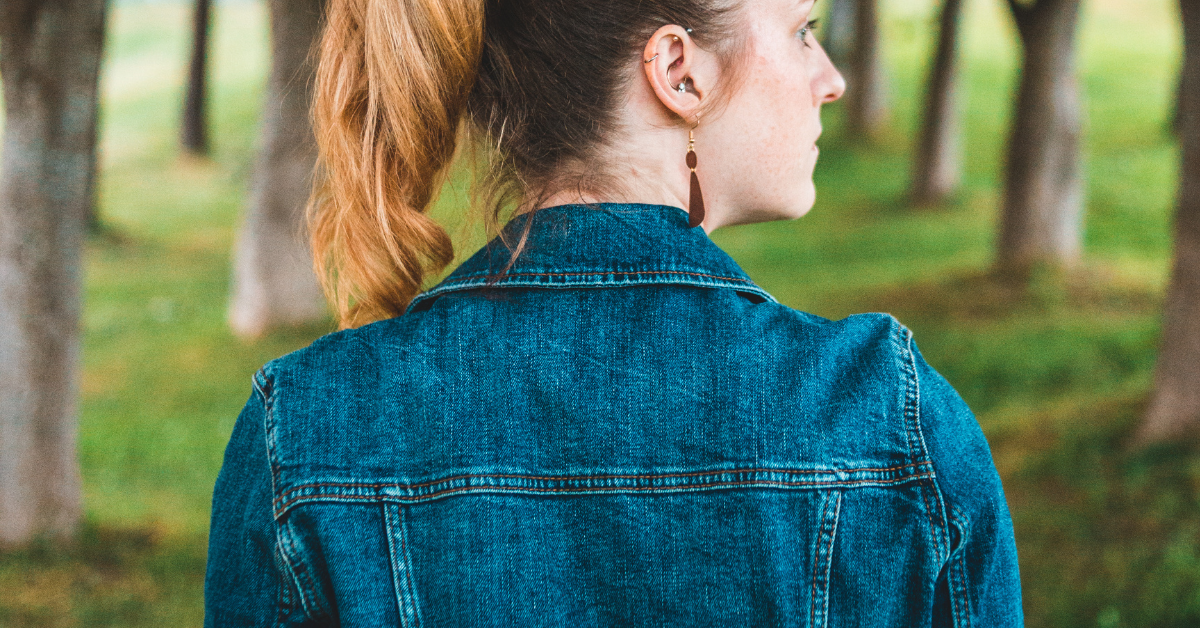 A person wearing a denim jacket outdoors